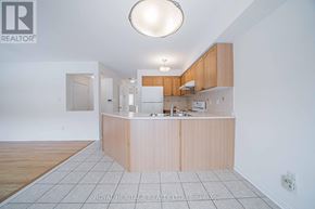 Markham (Berczy) apartment for rent - A kitchen with a white ceiling and a wooden island.