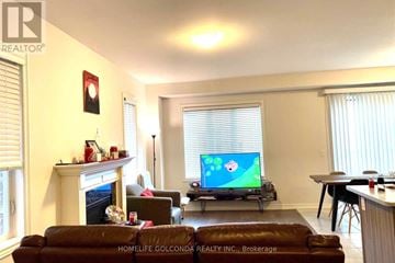 Milton (Fo Ford) apartment for rent - A living room with a fireplace and a television on.