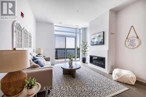 Kawartha Lakes (Fenelon Falls) condo for rent - A living room with a fireplace and a large window.