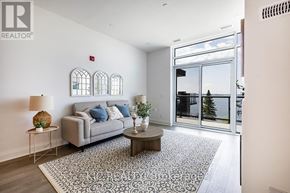 Kawartha Lakes (Fenelon Falls) condo for rent - A living room with a grey couch, a coffee table, and a rug.