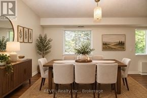 Welland (Prince Charles) condo for rent - A dining room with a wooden table and chairs.