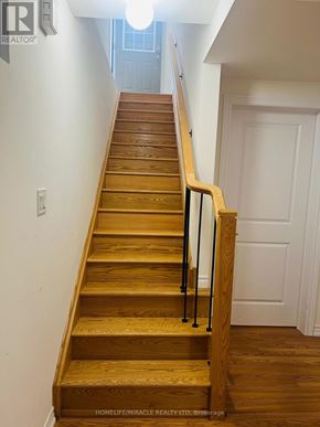 Barrie apartment for rent - A wooden staircase with a metal railing.