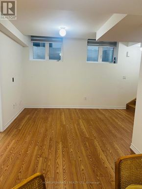 Barrie apartment for rent - A room with wooden flooring and a window with blinds.