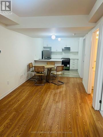 Barrie apartment for rent - A kitchen with a table and chairs in the middle of the room.