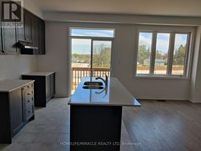 South-West Oxford townhouse for rent - A kitchen with a large island in the middle of the room.