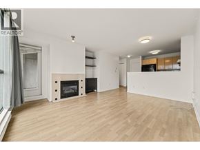 Burnaby apartment for rent - A spacious living room with a fireplace and wooden flooring.