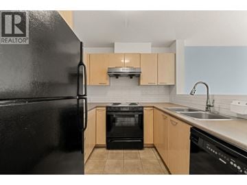 Burnaby apartment for rent - A black refrigerator with a logo on it in a kitchen.