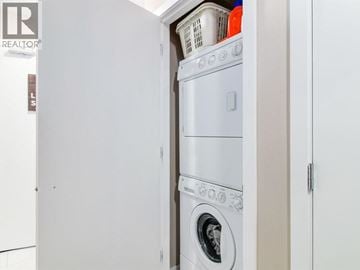 Vancouver apartment for rent - A white washing machine is in a small laundry room.