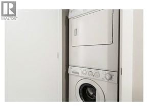 Vancouver apartment for rent - A white washing machine with the door open.
