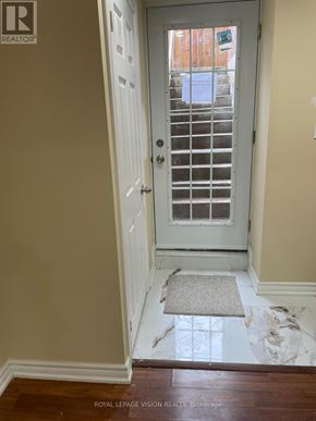Oshawa (Windfields) apartment for rent - A white door with a window in the background.