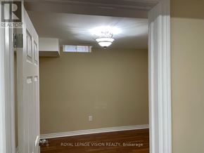 Oshawa (Windfields) apartment for rent - A white door with a Royal LePage Vision Realty sign on it.