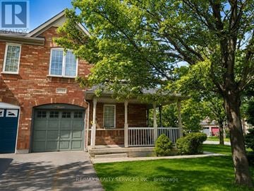 Mississauga (Churchill Meadows) townhouse for rent - A house with a garage and a tree in front.
