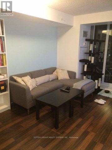 Toronto (Niagara) condo for rent - A living room with a grey couch and a coffee table.