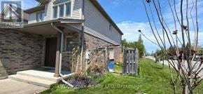 Niagara Falls (Forestview) apartment for rent - A house with a front yard and a sign that says "REALTOR".
