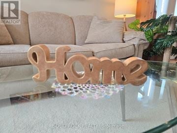 Ottawa townhouse for rent - A glass table with a wooden "home" sign on it.