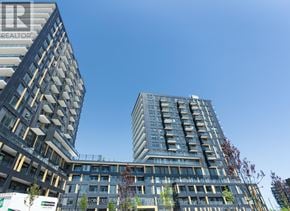Burlington (Alton) condo for rent - Two modern buildings with balconies and a clear blue sky in the background.