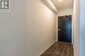 Burlington (Alton) condo for rent - A room with a black door and wooden floor.