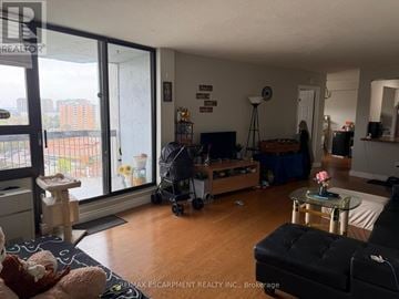 Mississauga (Mississauga Valleys) condo for rent - A living room with a black couch and a glass table.