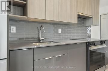 Burlington (Brant) condo for rent - A modern kitchen with a sink and stove.