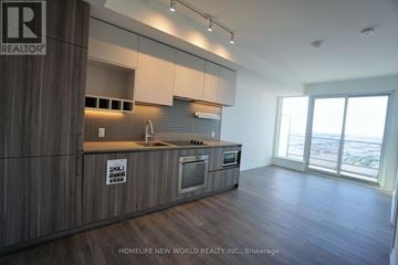 Vaughan (Vaughan Corporate Centre) condo for rent - A modern kitchen with wooden cabinets and a large window.