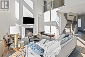 Blue Mountains apartment for rent - A modern living room with a staircase and a fireplace.