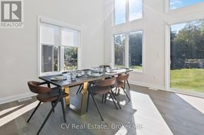 Blue Mountains apartment for rent - A dining room with a table set for six and a view of a lawn outside the window.