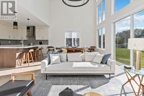 Blue Mountains apartment for rent - A modern living room with a large couch and a dining table.