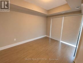 Kitchener condo for rent - A room with wooden flooring and a sliding door with blinds.
