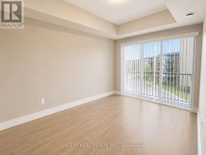 Kitchener condo for rent - A spacious room with a sliding glass door leading to a balcony.