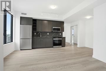 Burlington (Brant) condo for rent - A modern kitchen with dark brown cabinets and stainless steel appliances.
