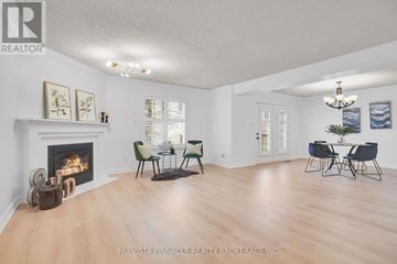 London North (North A) townhouse for rent - A living room with a fireplace and a dining table set up.