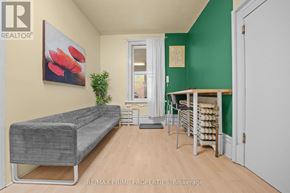 Ottawa multi-family for rent - A living room with a grey couch and a green wall.