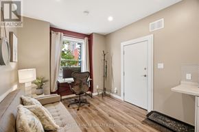 Ottawa multi-family for rent - A room with a couch, chair, and a window.