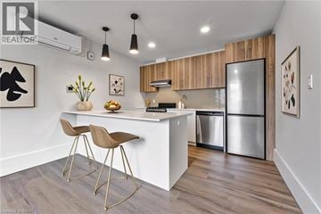 Cambridge apartment for rent - A modern kitchen with a white countertop and wooden cabinets.