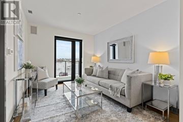 Thorold (Thorold Downtown) multi-family for rent - A well-lit living room with a glass coffee table and a grey sofa.