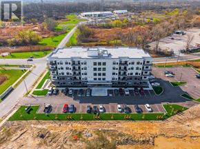 Thorold (Thorold Downtown) multi-family for rent - An aerial view of a large building with a parking lot in front.