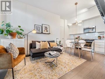Toronto (Niagara) condo for rent - A living room with a grey couch and a brown chair.