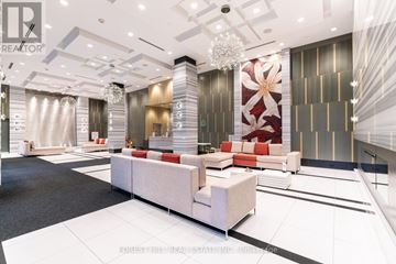 Toronto (Henry Farm) condo for rent - A modern living room with a white sofa set and a chandelier.