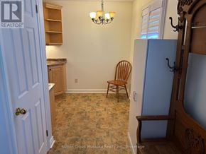 Huntsville (Chaffey) townhouse for rent - A room with a chair and a door.