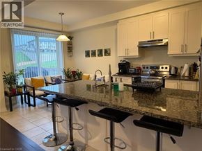 Cambridge apartment for rent - A kitchen with granite countertops and bar stools.