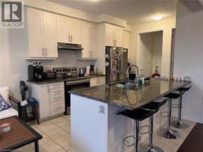 Cambridge apartment for rent - A kitchen with granite countertops and white cabinets.