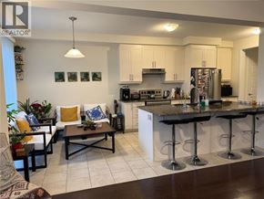 Cambridge apartment for rent - A well-lit kitchen with a bar area and a dining table.