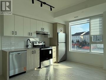 Burlington (Appleby) condo for rent - A modern kitchen with wooden cabinets and stainless steel appliances.