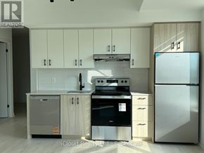 Burlington (Appleby) condo for rent - A modern kitchen with a refrigerator, oven, and sink.