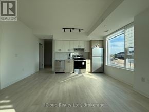 Burlington (Appleby) condo for rent - A kitchen with white cabinets and a stainless steel fridge is shown in this image.