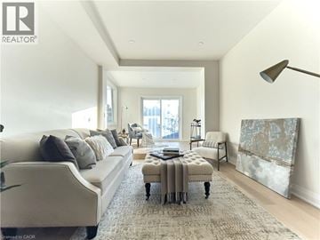 Hamilton apartment for rent - A well-lit, spacious living room with a large sofa and a coffee table.