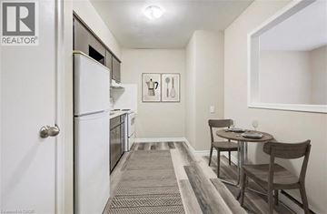 Kitchener apartment for rent - A small kitchen with a table and chairs.