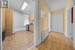 Ottawa multi-family for rent - A kitchen with wooden floors and a refrigerator.