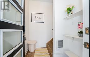 Niagara Falls (Downtown) townhouse for rent - A hallway with a white wall and a framed picture that says love.