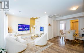 Niagara Falls (Downtown) townhouse for rent - A living room with a white couch and a television.